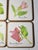 A set of six English square garden flower coasters made by Pimpernel. The coasters depict six differnt spring flowers....