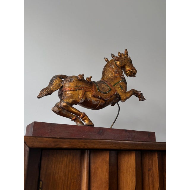 An exceptional 19th-century hand-carved polychrome wooden Indian horse, originally an architectural element most likely...