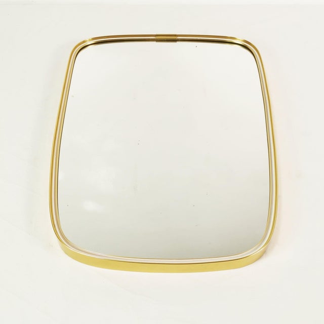 A wall mirror manufactured by Schon Form in Germany in the 1960s (signed). It is characterized by an asymmetrical form and...