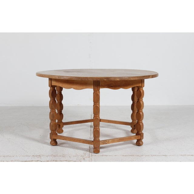 Henning Kjærnulf and Axel Einar Hjorth style round coffee table of heavy solid oak. Brutalist style with carved legs and...