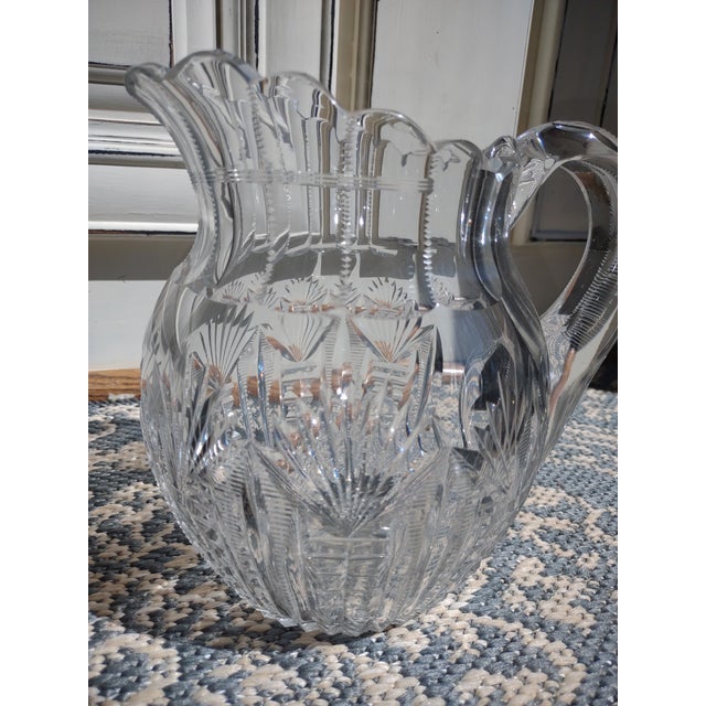 Offered is a beautiful antique cut glass water pitcher. It is very elegant with lots of zipper cuts and fan details. It...