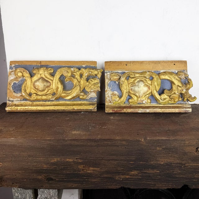 Pair of antique 18th century Italian carved wood architectural fragments with original gilding and traces of blue...