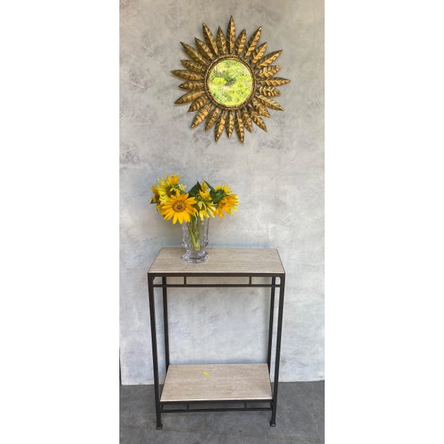 This striking Spanish sunburst mirror, dating back to the 1950s, features a gilt metal frame with a unique design of...