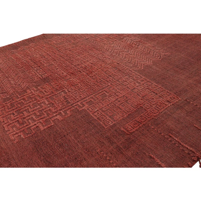 Made with hand-knotted wool and a high-low texture, this 9x14 modern Moroccan style rug in red features a design with a...