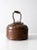 Decorative antique copper tea kettle featuring a teardrop hammered pattern across the top surface. The kettle includes a...
