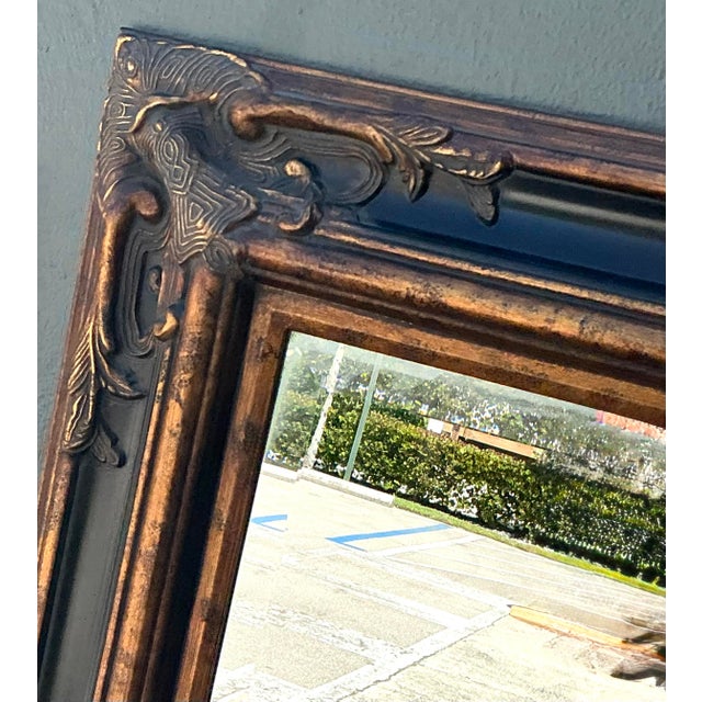 This monumental wall mirror by the renowned American maker Bassett is a striking example of Hollywood Regency elegance...