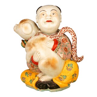 19th Century/Qing Dinasty Hand-Painted Glazed Porcelain Sitting Man With Scarf and Dog Figurine For Sale