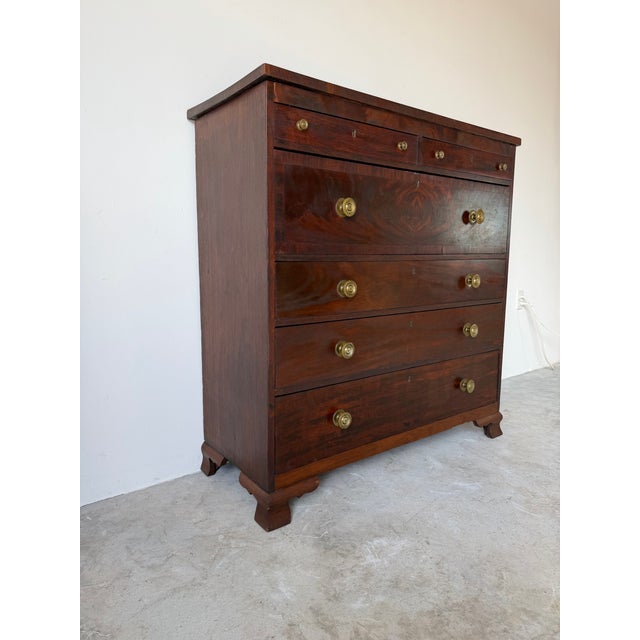 A beautiful 19th-century solid mahogany chest of drawers featuring a timeless English design with rich mahogany grain,...
