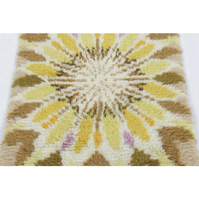 Hand-knotted in lush, high-pile wool in Sweden circa 1960-1970, this 2x4 vintage Swedish Rya rug is a bold new addition to...