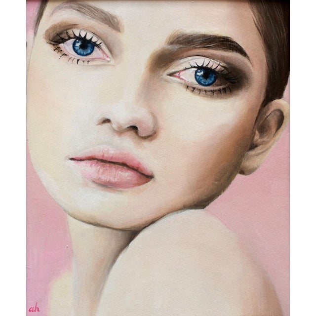 This colored pencil artwork presents a close-up portrait of a young woman, capturing her striking blue eyes and soft...