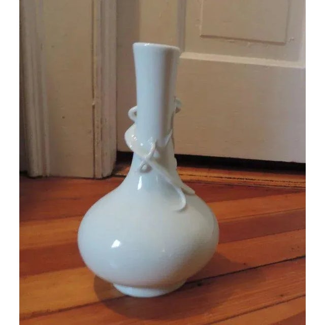 Exceptional Chinese white monochrome bottle shaped vase with an applied lizard to the throat. Marked to the base with...