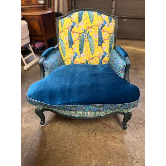 This is a custom upholstered Vintage French Bergere chair with peacock feather pattern on a yellow backdrop. There are 4...