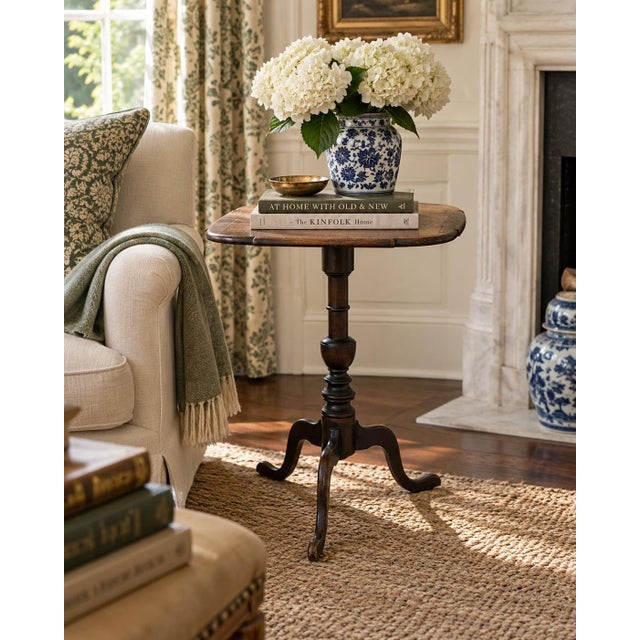 A handsome Georgian-style drinks table crafted in rich solid mahogany. The elegant turned pedestal and tripod base draw...