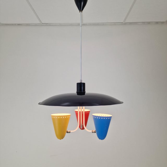 This pendant light is an example of mid-century technical precision and artistic expression. suspended from a refinished...