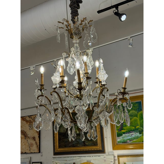 Design Plus Gallery presents a 10-Light Crystal Chandelier with Antique Gold-Finish Metal Frame. This chandelier pairs an...