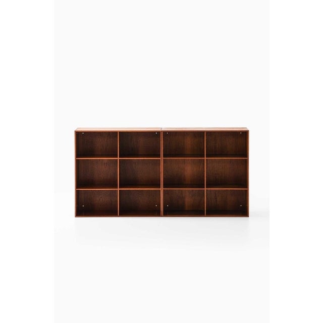 This pair of bookcases, designed by mogens koch in 1933 and produced by master cabinetmaker rud rasmussen in denmark,...