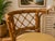 Vintage 1990s Honeymoon-style bamboo and rattan dining set featuring an oval glass-top table and two coordinating barrel-...