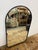 Design Plus Gallery presents the Arched Burnished Brass Mirror from Rejuvenation. The mirror has a sleek brass metal frame...