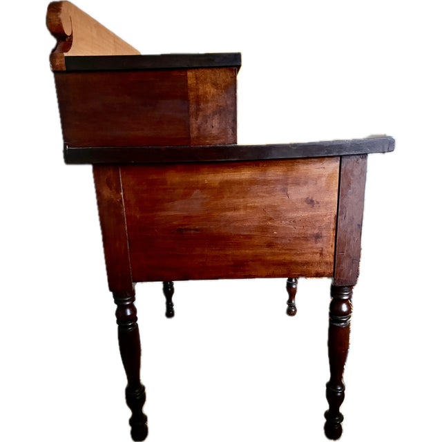 Charming provincial Pennsylvania work table designed in a Sheraton style. The two-tiered piece is made from cherry wood...