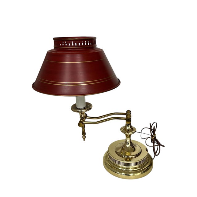 Vintage Italian tole style brass body desk lamp. Shade is dark red metal with a simple design of gold bands. Measures 11”...