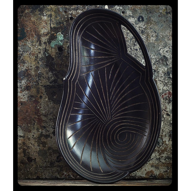 A unique ceramic platter from Japan, crafted in the mingei style (folk crafts movement). It was likely created during the...