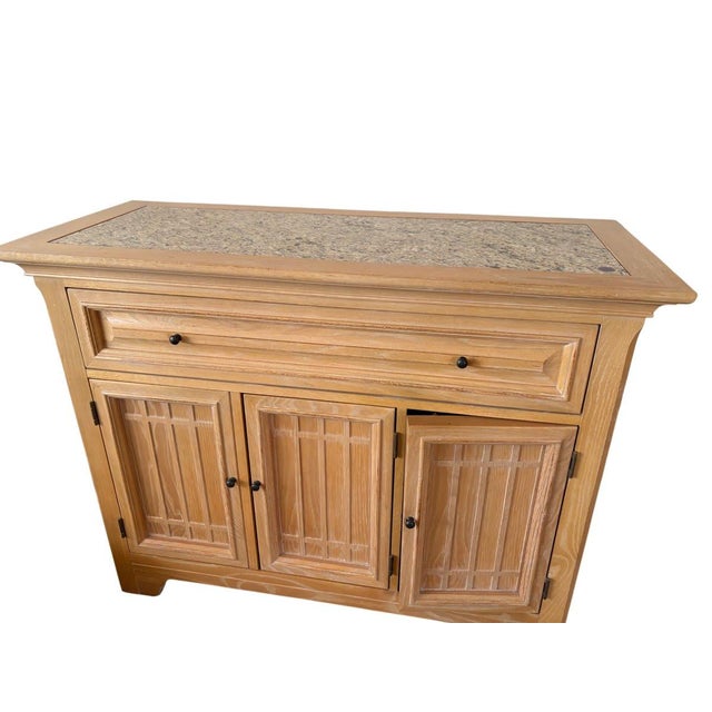 This handsome buffet sideboard combines the warmth of light oak with an elegant inset granite top, creating a piece that...
