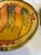 Vibrant pair of Italica Ars ceramic plates from Italy, each featuring a bold, hand-painted tropical fish motif on a warm...
