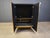 Hollywood regency black lacquer and brass bar cabinet with a black marble top. The cabinet offers plenty of storage space...