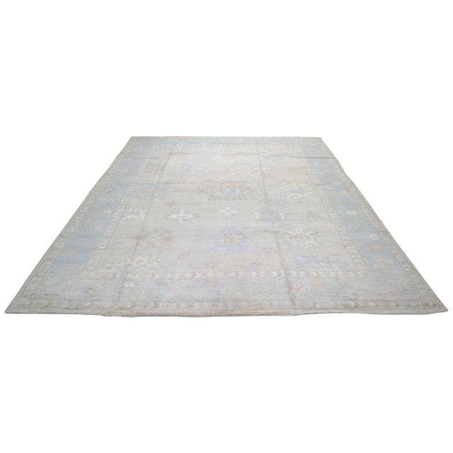 Oushak hand knotted wool rug with natural colors, floral style, and fine weave.