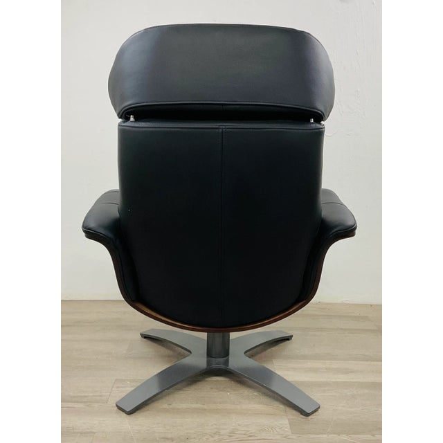 Timeless Mid-Century Modern Eames Inspired Italian Black Leather Lounge Chair and Ottoman, warm mahogany finished wood...
