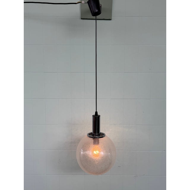 Pendant lamp made in Italy in the 1960s Transparent Murano blown glass sphere crafted using the "Pulegoso" technique and...