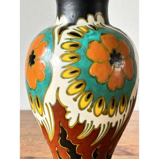 A stunning art deco vase in the "grety" decor, model 805, produced by plateelbakkerij zuid-holland (pzh), one of the most...