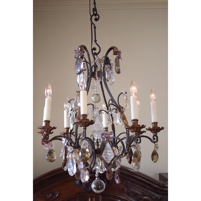 A superior quality wrought iron and gilt chandelier in the Louis XV style, the craftsmanship and design indicative of the...