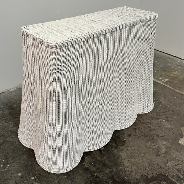 Hand woven natural rattan skirt table in white lacquered finish. Indoor and covered outdoor safe. Sturdy metal frame...