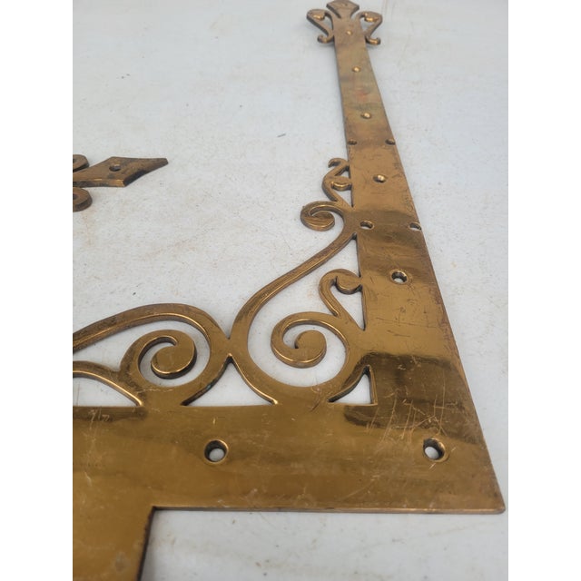 A striking matched set of four large solid-brass architectural corner braces featuring ornate openwork scroll decoration...