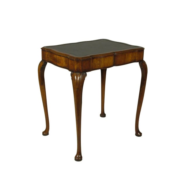 A late 19th-C. English George II-Style diminutive writing table with a single frieze drawer, a black leather writing...