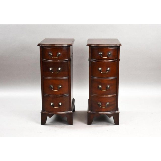 An attractive and practical pair of mahogany bow-front bedside chests of drawers, elegantly designed in the Georgian style...