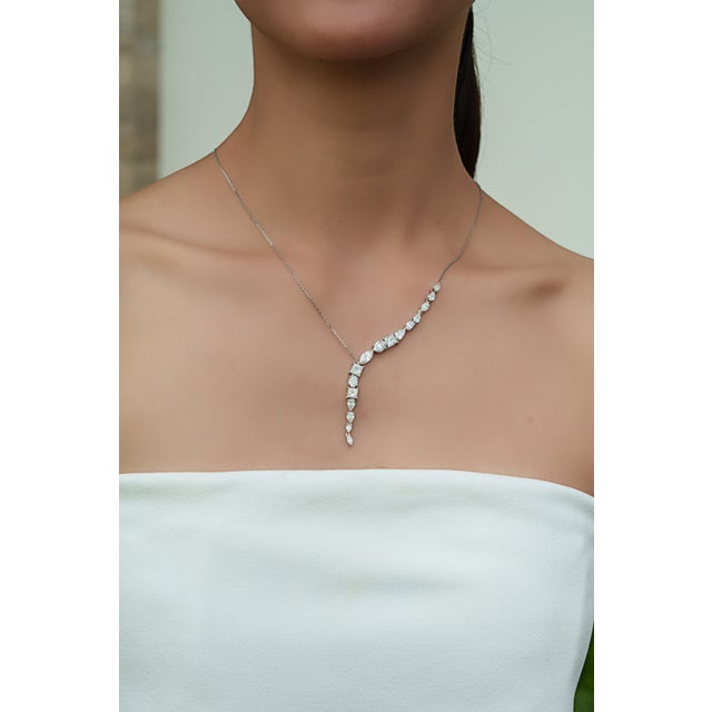 This elegant drop Y-necklace features 5.54 carats set in 14K white gold. The sparkling multi-shape diamonds in mixed...