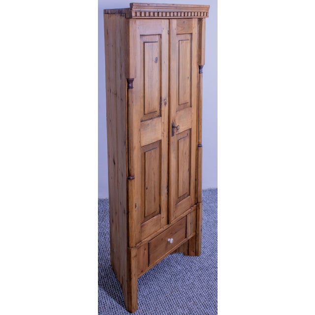 This charming antique corner cabinet is crafted from solid pine and has been carefully stripped and waxed to highlight the...