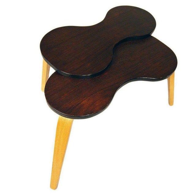 Rare Mid-Century Modern side table features a biomorphic top in a rich walnut stain resting on contrasting bent oak...
