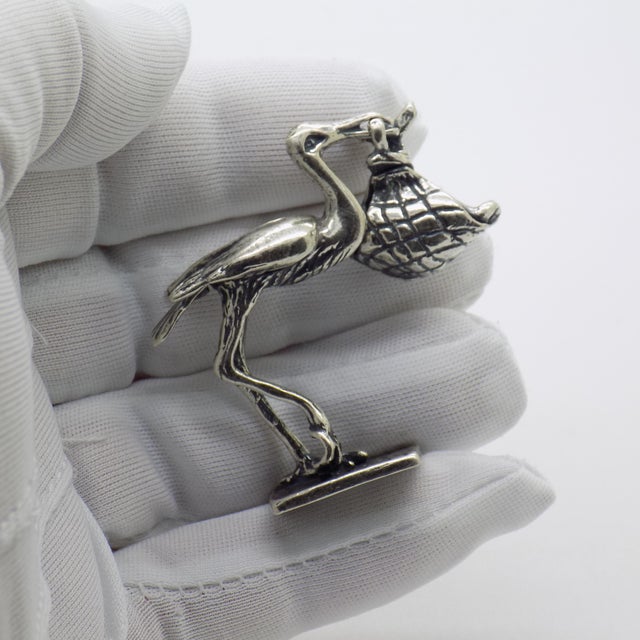 A charming vintage miniature depicting a stork carrying a newborn baby, handmade in Italy between the 1980s and 1990s in...