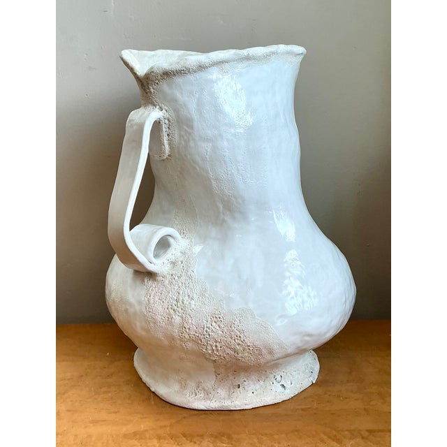 This striking monumental white ceramic vase captures the essence of artisanal craftsmanship with its impressive scale and...