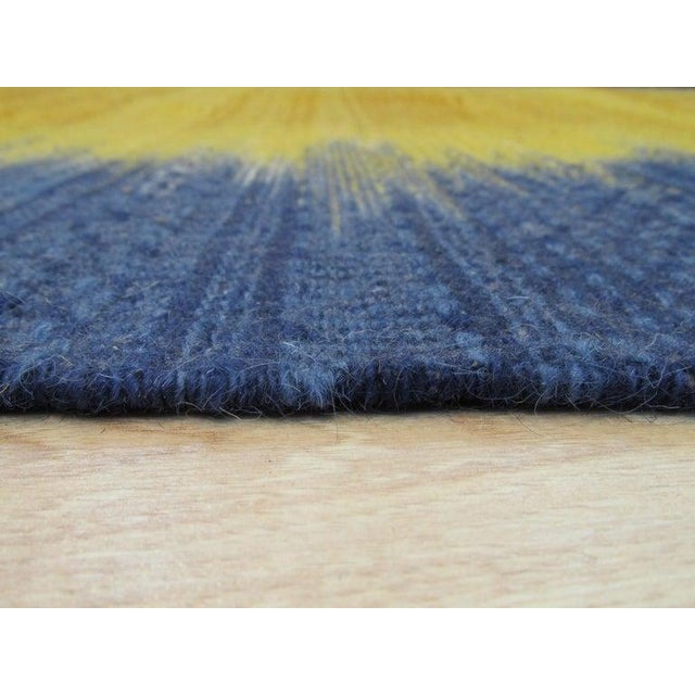 This yellow, gold, and orange wool rug features a sturdy flat weave construction typical of authentic Kilim styles....