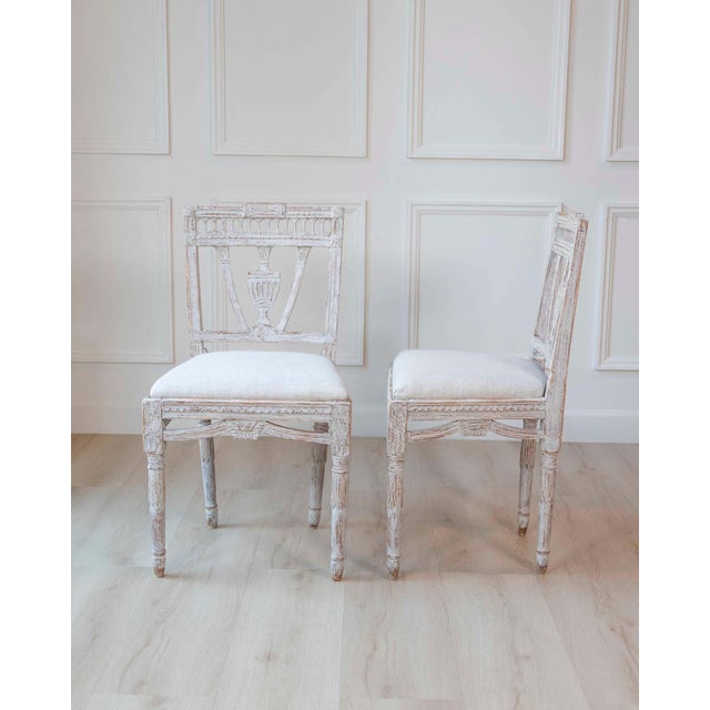 A refined pair of late 18th-century Swedish Gustavian dining chairs, showcasing the balance and symmetry of neoclassical...