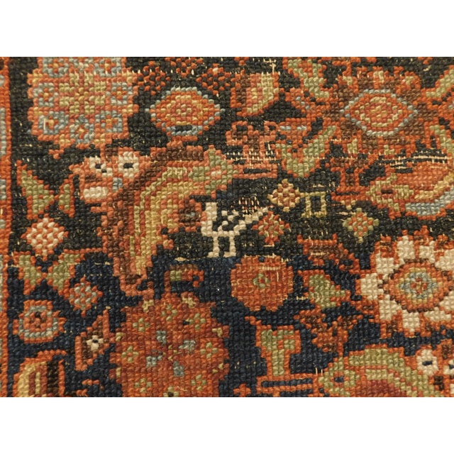 Colorful floral and geometric motifs on a mainly blue background. Discoloration, called abrash, due to age. Multiple...