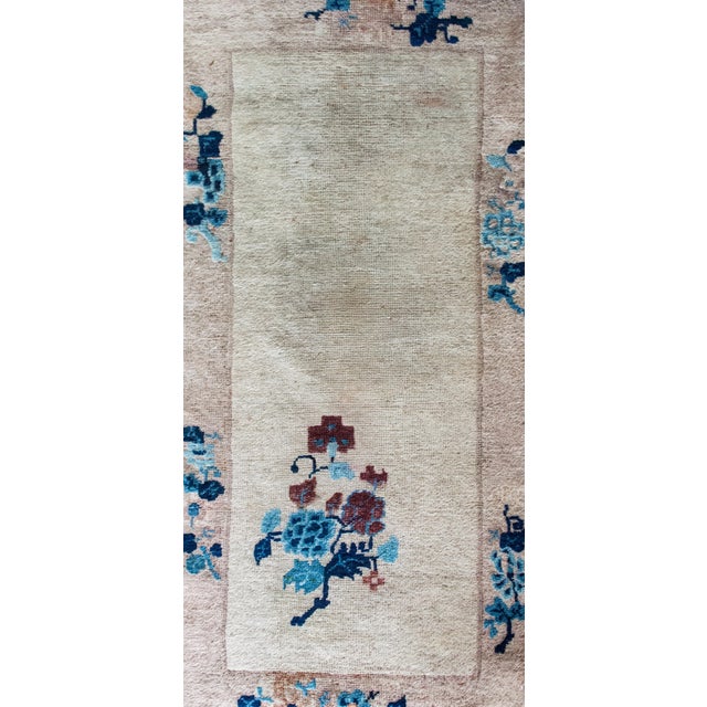 This early 20th-century Chinese Art Deco rug is a quietly dramatic study in elegance and asymmetry. The soft gray field is...