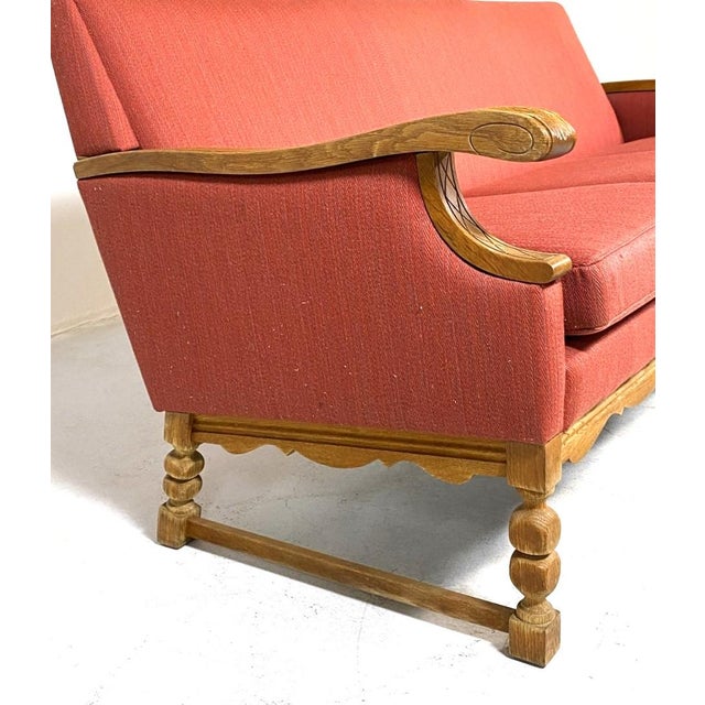 A retro-cool Danish mid century modern, circa 1960's sofa with a carved wood base, stretcher sides, and figured decorative...