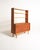 Teak bookcase with open shelves, a pull-out desk, and a lower compartment with sliding doors and an internal shelf....