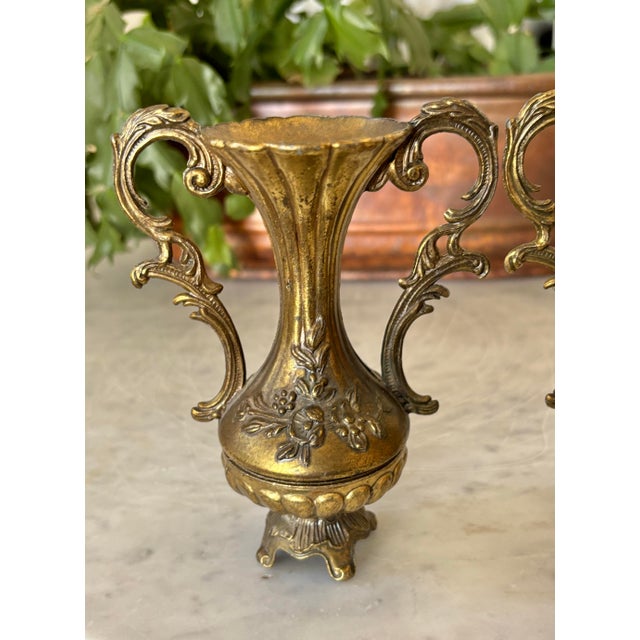Charming pair of brass-plated Italian urns, circa the mid 20th century. Most items found at Pub & Oasis are vintage and...