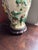 Table lamp made from a porcelain vase with raised polychrome relief figures of warriors among trees in green, yellow, and...